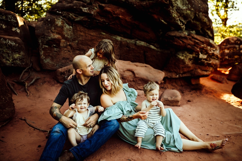Washington State Family Photographer, family sitting together on rocky embankment